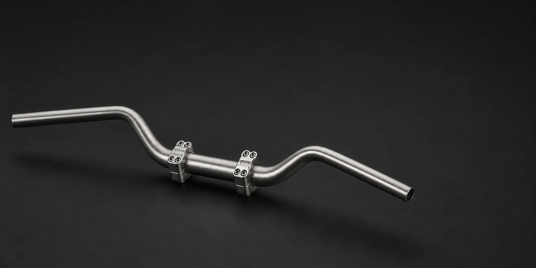 Finished motorcycle handlebar with multi-radius bends