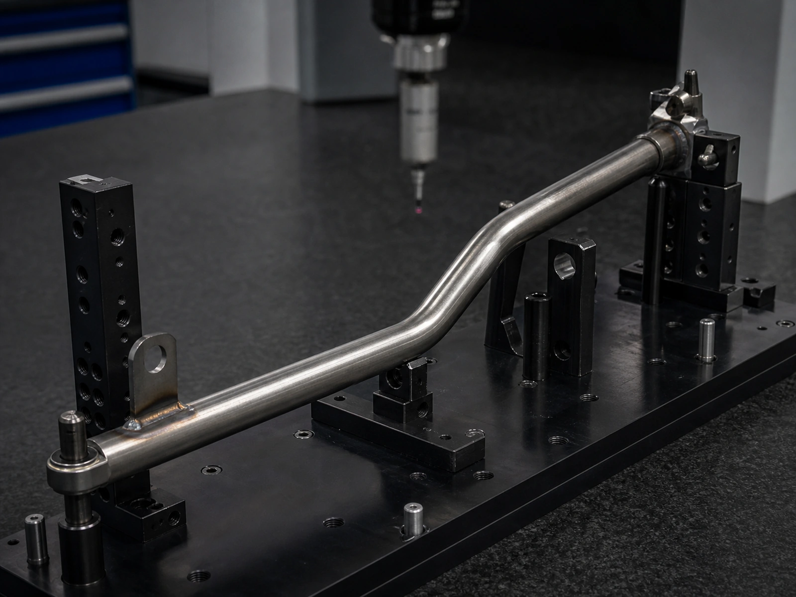 Bent automotive tube positioned in a dimensional checking fixture