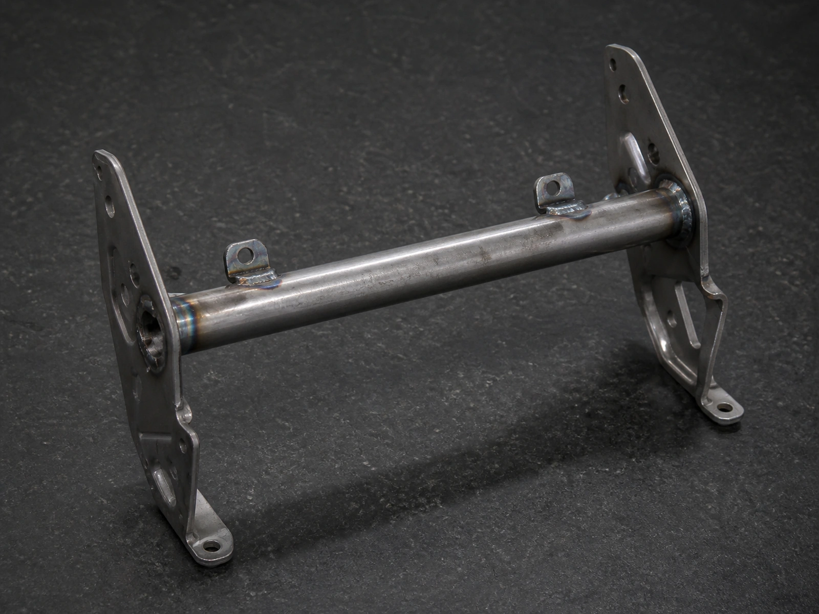 Automotive seat cross tube with mounting brackets